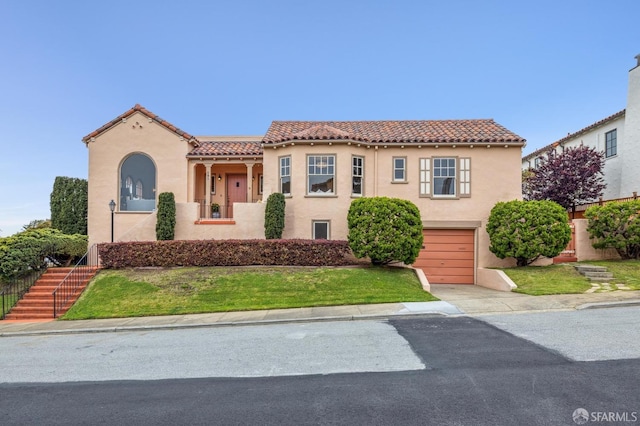 mediterranean / spanish house featuring a tiled roof, a garage, stucco siding, and concrete driveway