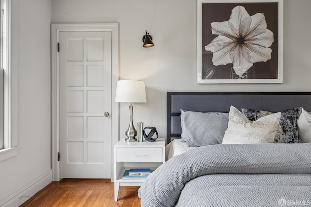 bedroom with wood finished floors