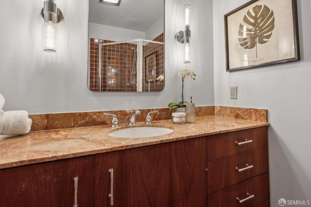 bathroom featuring a shower stall and vanity