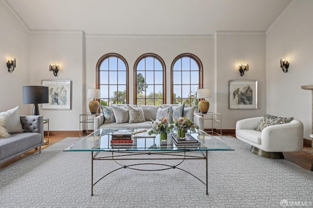 living room with crown molding, baseboards, and plenty of natural light