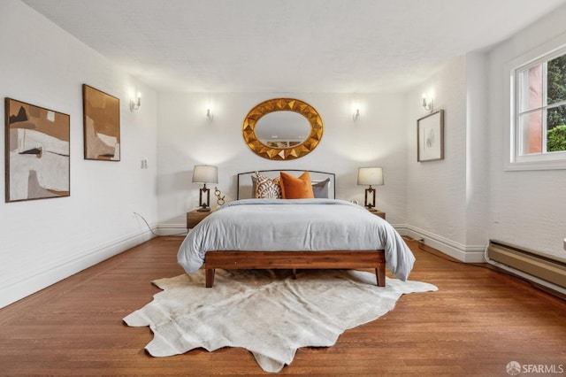 bedroom featuring baseboards and wood finished floors