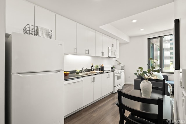 kitchen featuring white appliances, dark hardwood / wood-style flooring, sink, and white cabinets