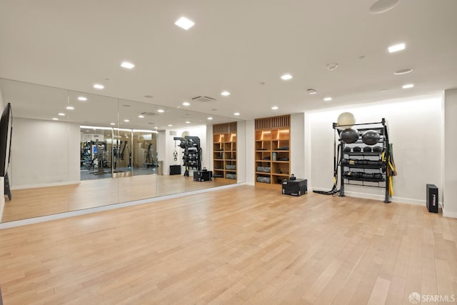 exercise area with light hardwood / wood-style flooring