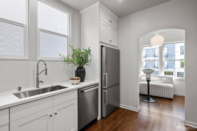 kitchen featuring dark hardwood / wood-style floors, white cabinetry, sink, and appliances with stainless steel finishes