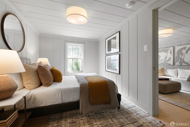 bedroom with crown molding and hardwood / wood-style floors