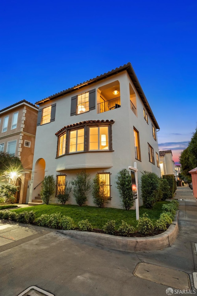 mediterranean / spanish house featuring a balcony