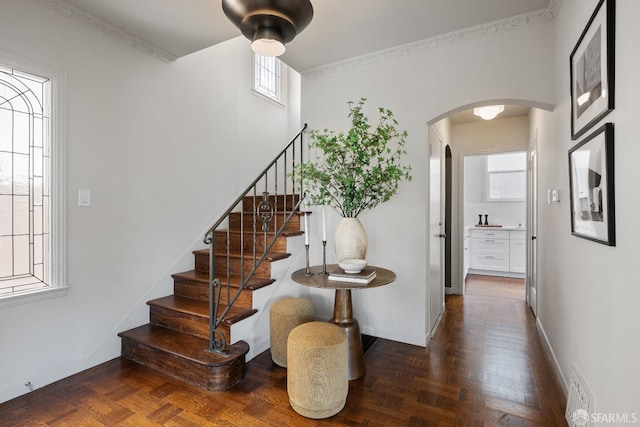 stairway featuring crown molding