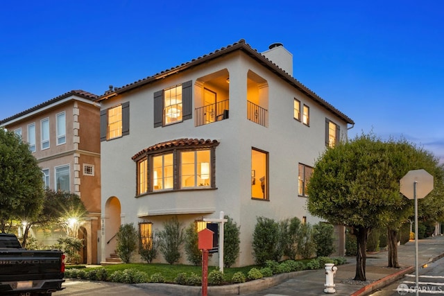 mediterranean / spanish-style home with a balcony