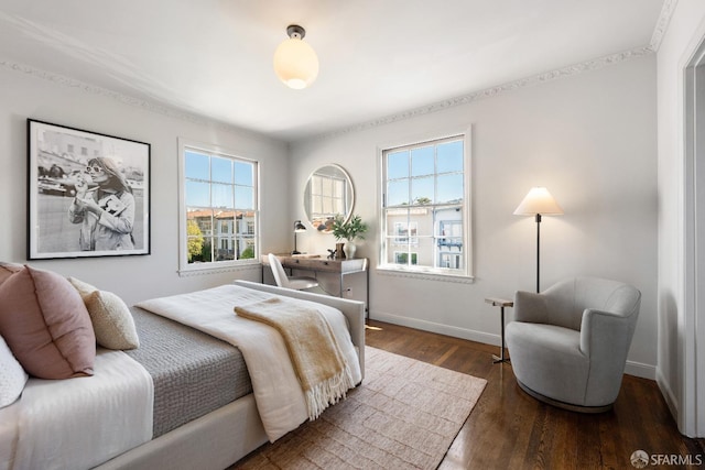 bedroom featuring dark hardwood / wood-style flooring and multiple windows