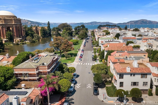 drone / aerial view featuring a water and mountain view