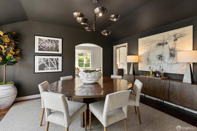 dining space featuring a chandelier and lofted ceiling