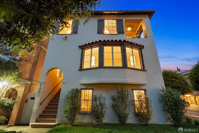 view of front of home with a balcony