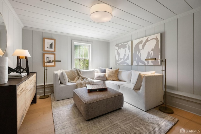 living room featuring crown molding and light hardwood / wood-style floors