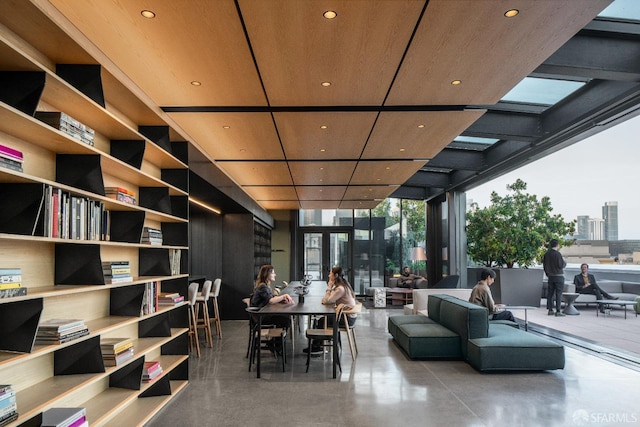 dining space featuring expansive windows and concrete flooring