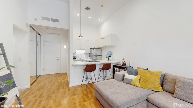 460 N Civic Dr Unit 317, Walnut Creek, CA 94596 - living room featuring a high ceiling, light wood finished floors, recessed lighting, and baseboards