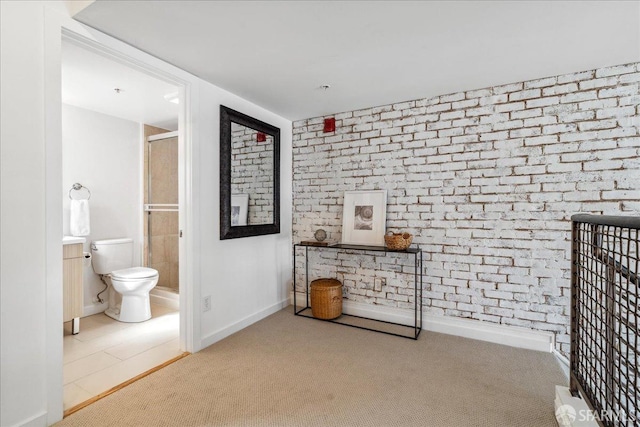 corridor with brick wall, baseboards, and carpet