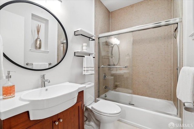 bathroom with enclosed tub / shower combo, toilet, and vanity