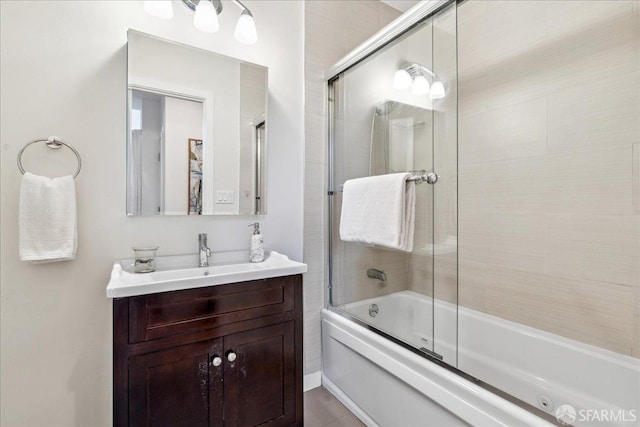 bathroom with combined bath / shower with glass door and vanity