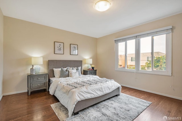 bedroom with baseboards and wood finished floors