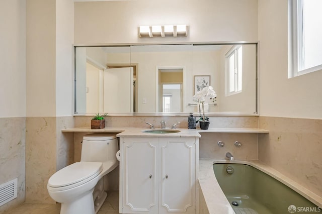 full bathroom featuring vanity, toilet, a bath, and visible vents