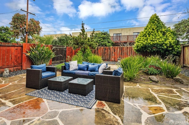 view of patio with an outdoor living space and a fenced backyard