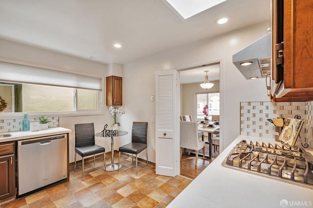 kitchen featuring light countertops, backsplash, recessed lighting, and appliances with stainless steel finishes