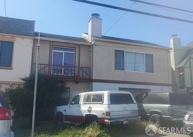 view of front of home with a balcony