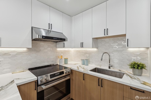 2055 42nd Ave, San Francisco, CA 94116 - kitchen with under cabinet range hood, stainless steel range with electric stovetop, backsplash, light stone counters, and white cabinets