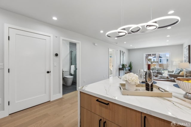 2055 42nd Ave, San Francisco, CA 94116 - kitchen with light wood-style floors, a chandelier, open floor plan, light stone counters, and recessed lighting
