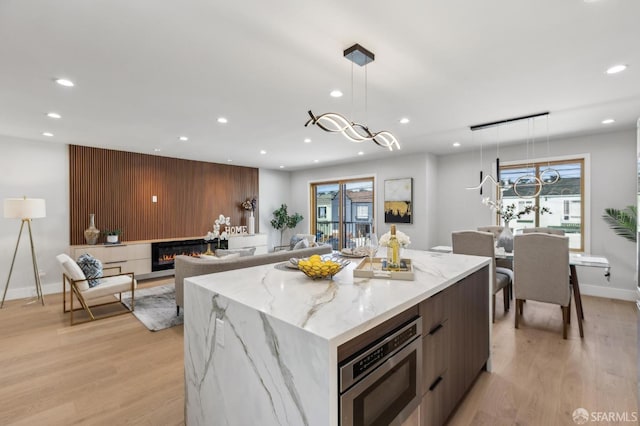 2055 42nd Ave, San Francisco, CA 94116 - kitchen with stainless steel microwave, recessed lighting, modern cabinets, light wood-type flooring, and healthy amount of natural light
