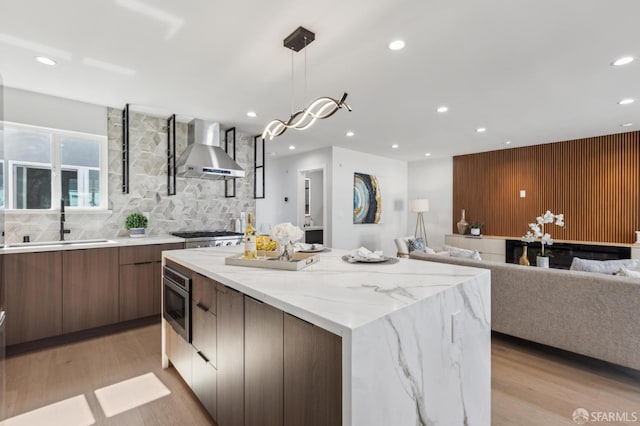 2055 42nd Ave, San Francisco, CA 94116 - kitchen featuring wall chimney exhaust hood, modern cabinets, a center island, stainless steel appliances, and recessed lighting