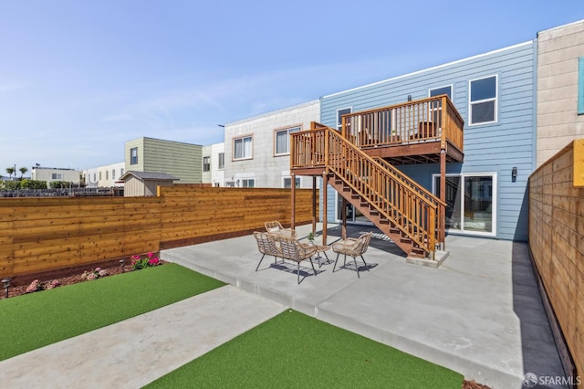 2055 42nd Ave, San Francisco, CA 94116 - fenced backyard with a deck, stairway, and a patio