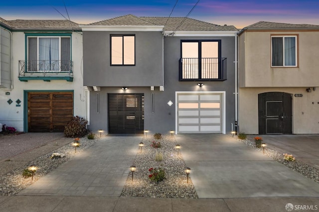 2055 42nd Ave, San Francisco, CA 94116 - view of property with stucco siding, a balcony, concrete driveway, and a garage