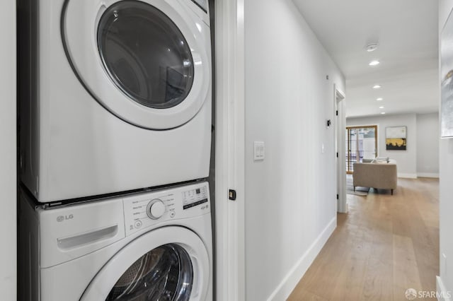 2055 42nd Ave, San Francisco, CA 94116 - washroom featuring stacked washing machine and dryer, recessed lighting, and light wood finished floors