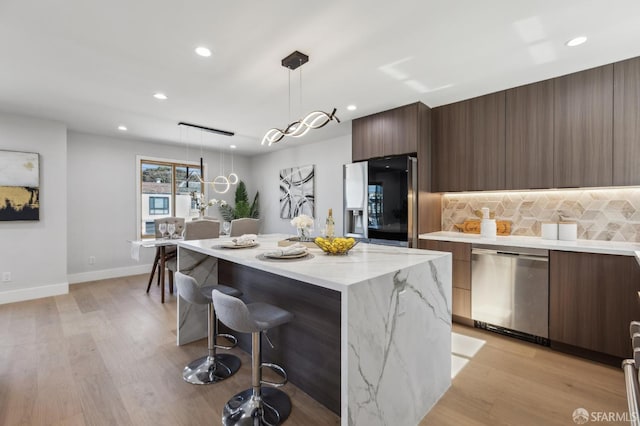 2055 42nd Ave, San Francisco, CA 94116 - kitchen with modern cabinets, dishwasher, refrigerator with ice dispenser, a kitchen bar, and decorative backsplash