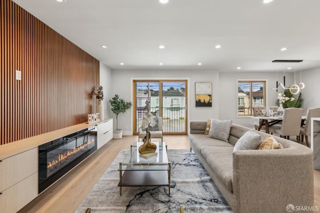 2055 42nd Ave, San Francisco, CA 94116 - living area featuring recessed lighting, light wood-type flooring, plenty of natural light, a glass covered fireplace, and wooden walls
