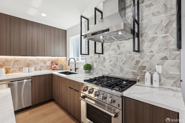 2055 42nd Ave, San Francisco, CA 94116 - kitchen featuring wall chimney exhaust hood, appliances with stainless steel finishes, modern cabinets, light stone counters, and decorative backsplash