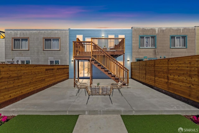 2055 42nd Ave, San Francisco, CA 94116 - back of property at dusk featuring a fenced backyard, a patio, stairs, and a deck