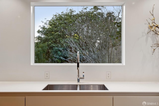 kitchen with plenty of natural light, light countertops, and a sink