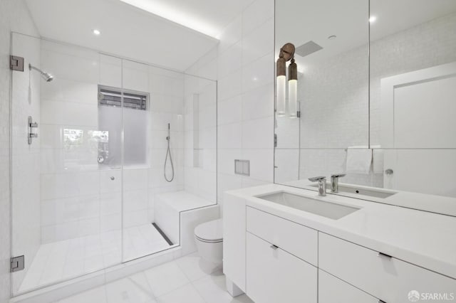 full bath with toilet, a shower stall, tile walls, and vanity