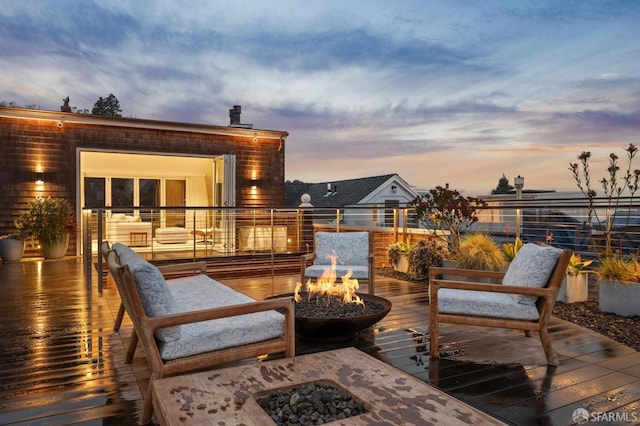 deck at dusk with an outdoor fire pit