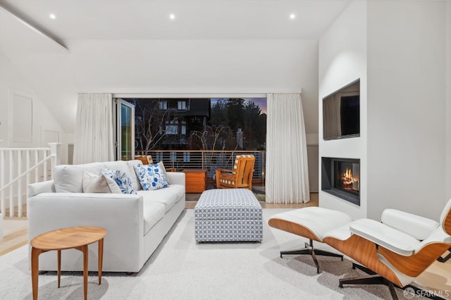 living room with a glass covered fireplace and recessed lighting