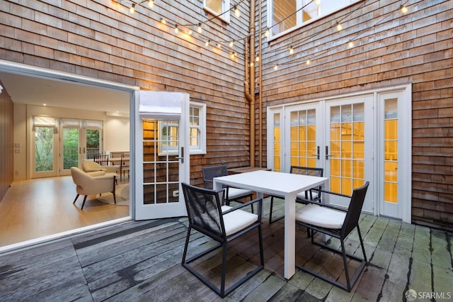 wooden deck featuring french doors and outdoor dining area