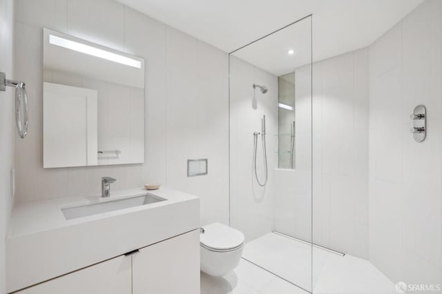 bathroom featuring vanity, walk in shower, and toilet