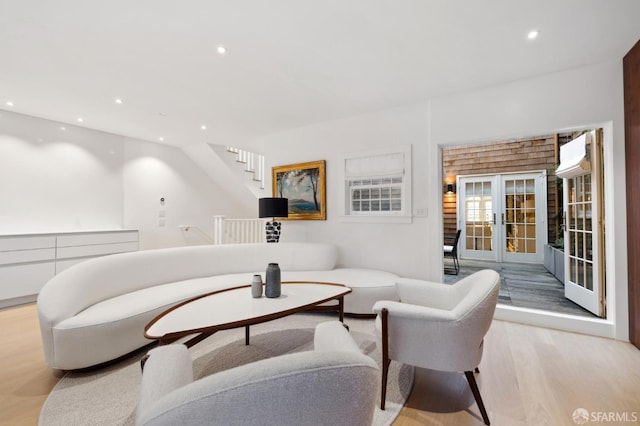 living area with light wood-type flooring, french doors, and recessed lighting