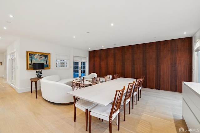 dining room with wood walls and recessed lighting