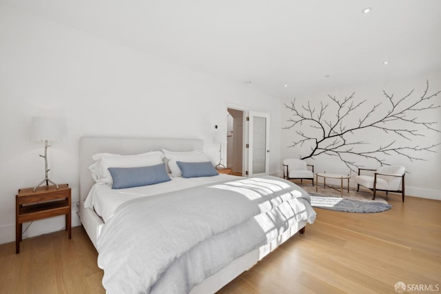 bedroom featuring recessed lighting and wood finished floors