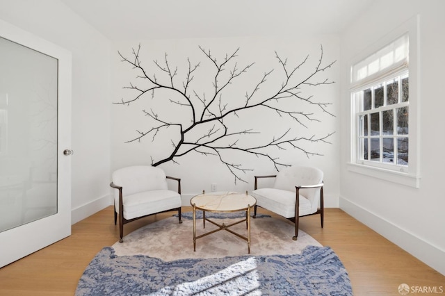 living area with light wood finished floors and baseboards