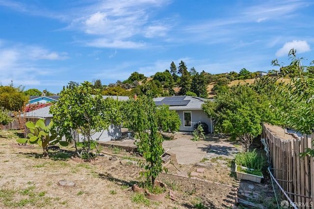 2675 Simas Ave, Pinole, CA 94564 - rear view of property featuring solar panels, stucco siding, and a garden