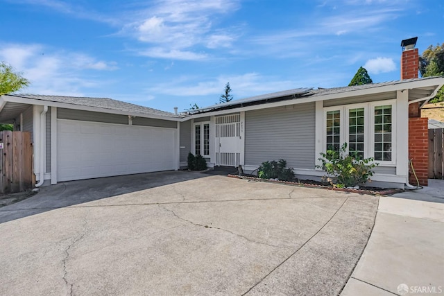 2675 Simas Ave, Pinole, CA 94564 - ranch-style home with driveway, solar panels, a garage, and a chimney